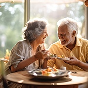 Couple eating together with their dentures