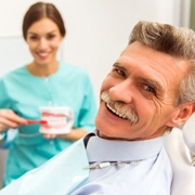 man at a checkup with his implant dentist in Fairfax