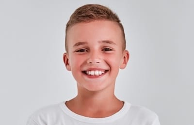 Young boy with healthy smile thanks to children's dentistry