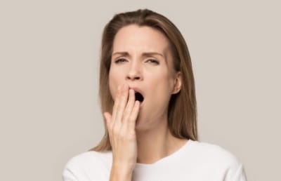 Yawning woman in need of sleep apnea therapy