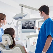 Dentist explaining how dental implants work in Fairfax