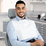 Patient smiling while sitting in treatment chair