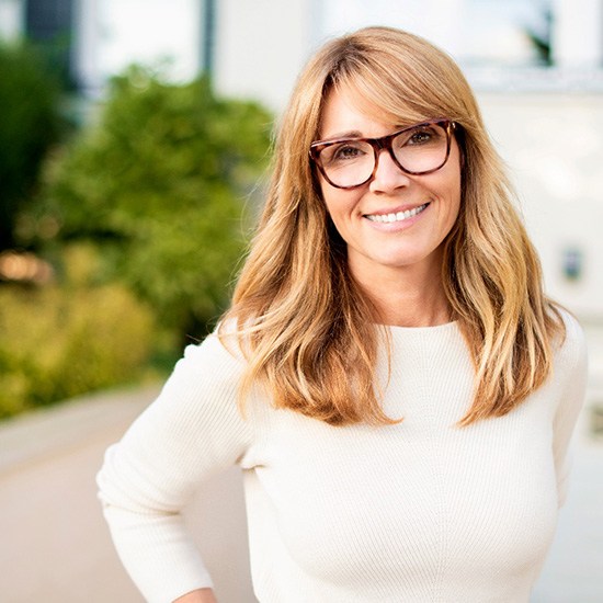 smiling woman with dental bridge in Fairfax  