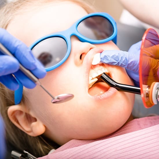 Child receiving dental sealants