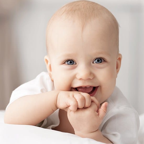 Laughing infant after lip and tongue tie treatment