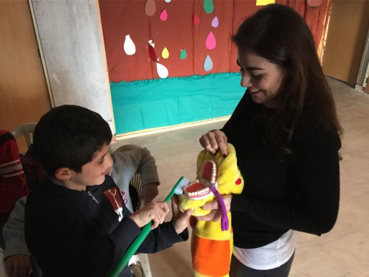 Doctor Ghumrawi helping a kid