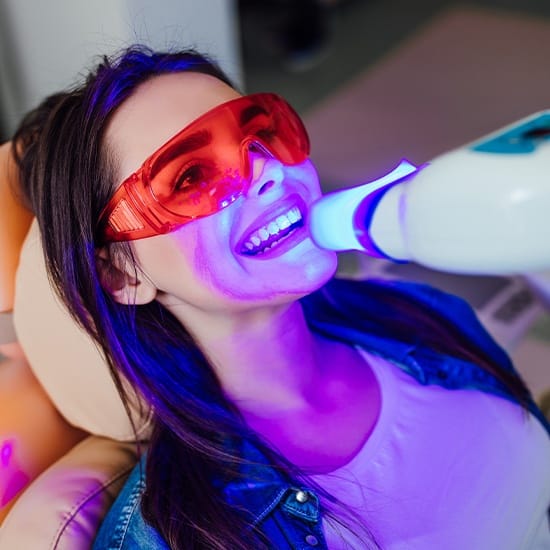 Patient receiving in office teeth whitening