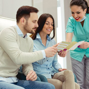 Patient in Fairfax talking with their dentist's office staff before a root canal