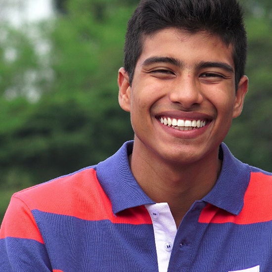 young man smiling with a dental crown in Fairfax