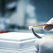 A dental technician working on dental crowns