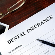 A dental insurance form on a wooden table