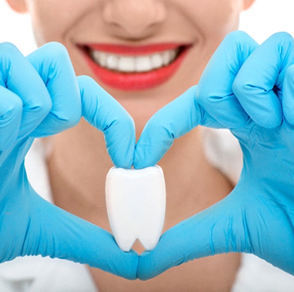 Heart around tooth using gloved hands