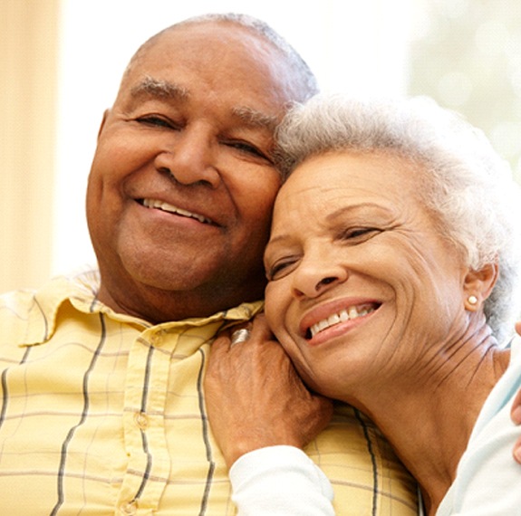 happy older couple hugging