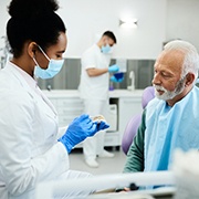 Man at the dentist learning about dentures