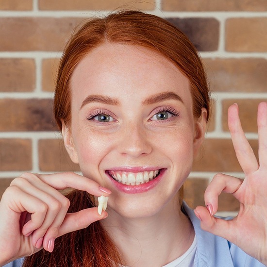 Woman smiling after tooth extraction in Fairfax