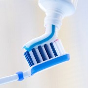 toothpaste being put onto a toothbrush