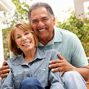 An older man and woman show off their new smiles with dental implants in Fairfax