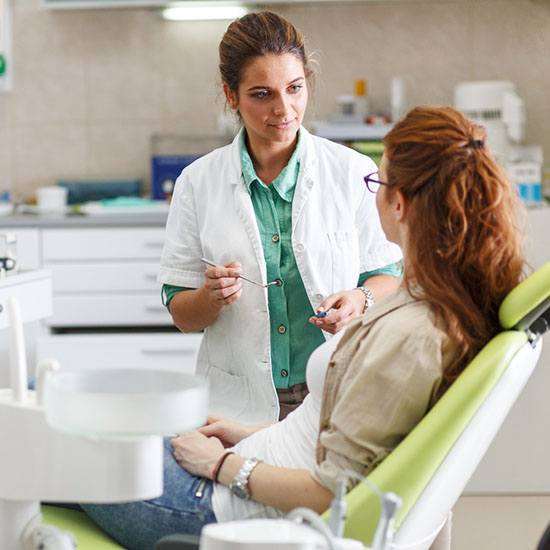 a dentist explaining dental implant post-op instructions in Fairfax