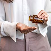 a person taking medication per dental implant post-op instructions