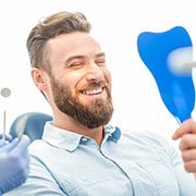 a woman brushing her teeth and dental implants