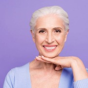 Older woman with dental implants in Fairfax smiling