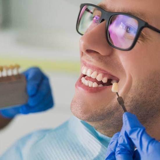 A patient completing treatment for a dental implant in Fairfax