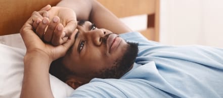 Frustrated man unable to sleep in need of sleep apnea therapy