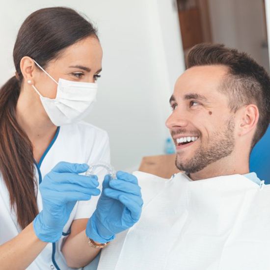 Fairfax dentist and patient discussing Invisalign in Fairfax
