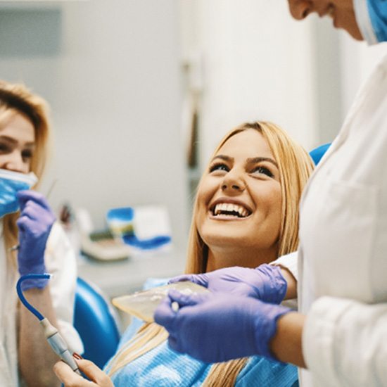 patient smiling while talking to dentist 