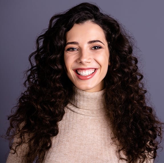 Woman smiling after relaxed sedation dentistry visit