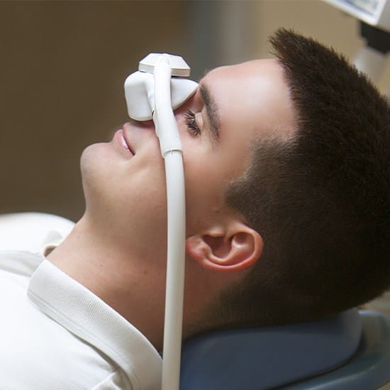 Relaxed patient with nitroux oxide sedation dentistry mask