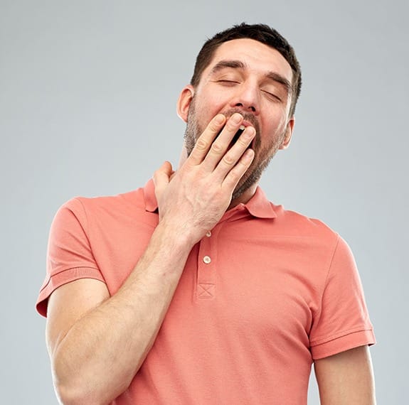 Yawning man in need of sleep apnea therapy