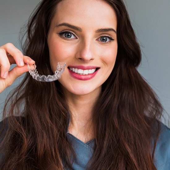 Young woman with clear aligner in Fairfax