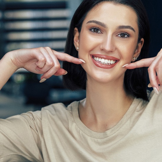 A young man smiling after completing Spark clear aligners in Fairfax