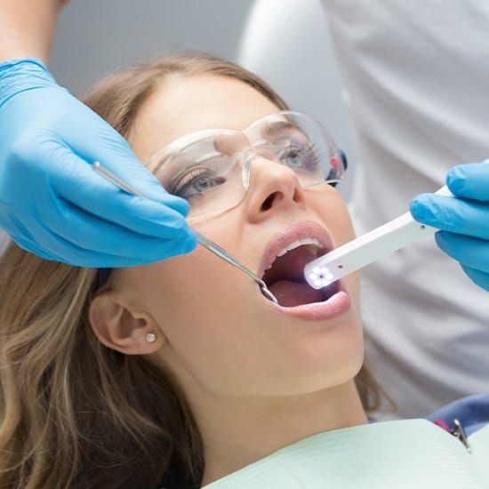 Dentist using intraoral camera to capture images of patient's teeth