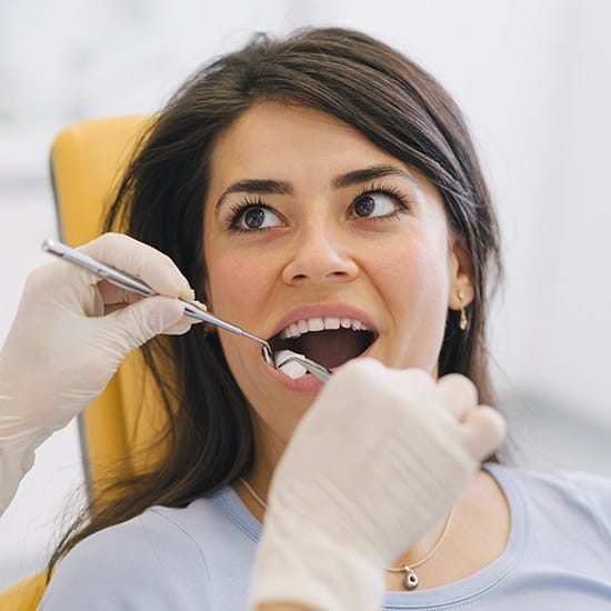 Young woman receiving wisdom tooth extraction